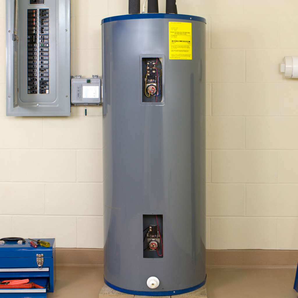 New gray tank water heater in a residential basement; toolbox on the floor nearby.