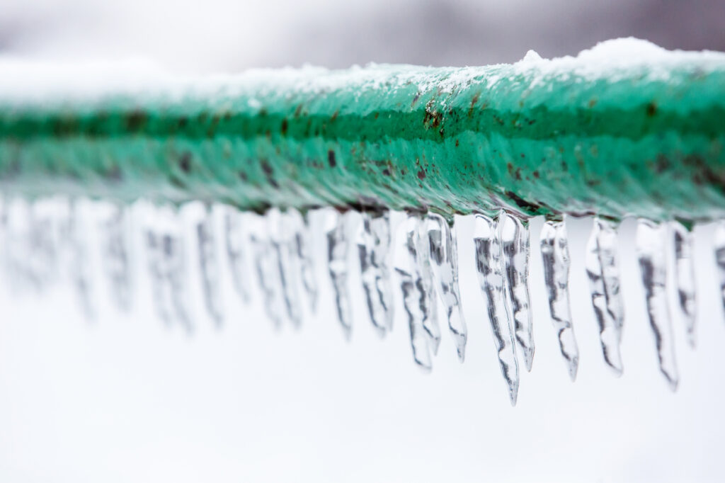 Frozen icy down pipe, icicles